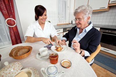 Nurse Feeding an Elderly Woman