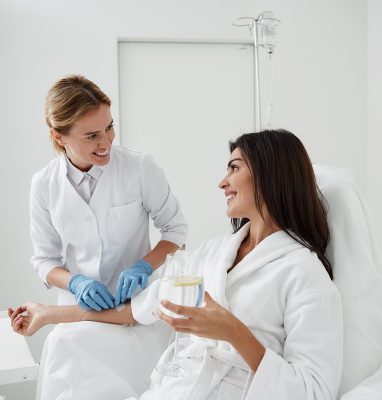 Doctor in Sterile Gloves Checking IV infusion